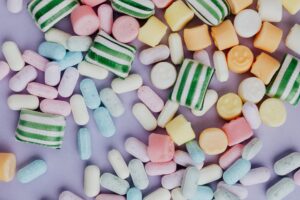 multicolored sweets on light purple background